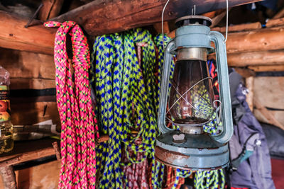 Close-up of lantern hanging against ropes