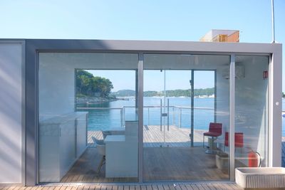 Reflection of building on swimming pool against sky