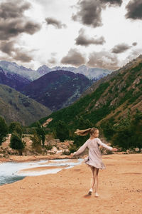 Rear view of woman standing on mountain