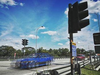 Low angle view of road signs against sky