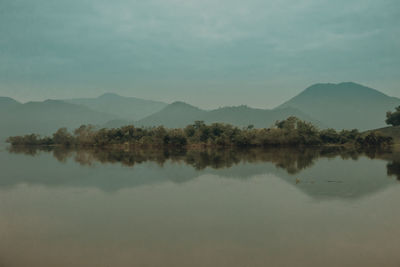 Scenic view of lake and mountains against sky