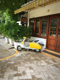 Yellow car on street by building