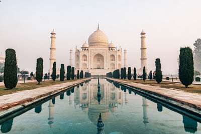 Taj mahal at foggy sunrise in winter