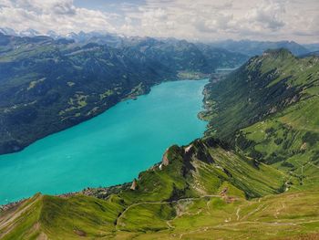 High angle view of sea and mountains against sky