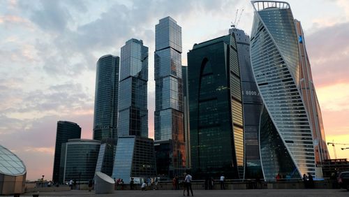 Low angle view of buildings against cloudy sky