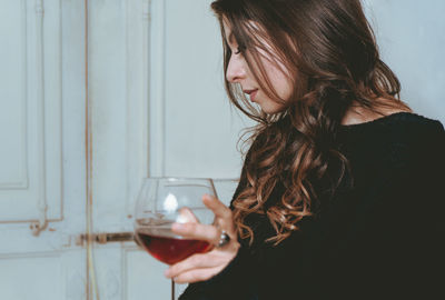 Midsection of woman drinking water from glass