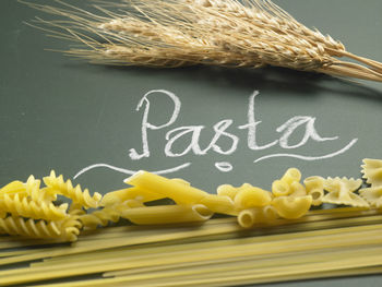 Close-up of raw pastas and text on black background