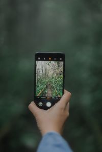 Midsection of man using mobile phone