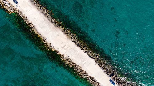 Aerial view of road amidst sea