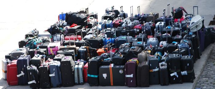 Luggage on sidewalk in city