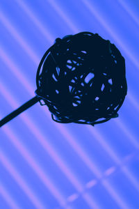 Close-up of object against blue sky