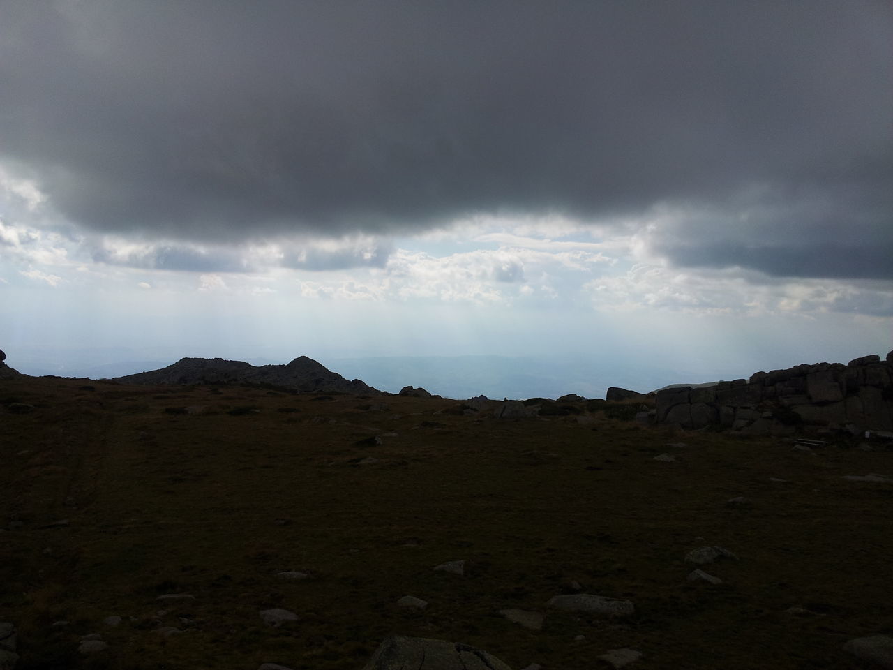 sky, tranquil scene, cloud - sky, tranquility, scenics, landscape, cloudy, beauty in nature, nature, mountain, cloud, overcast, non-urban scene, remote, idyllic, rock - object, physical geography, dusk, weather, horizon over land