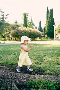 Full length of girl wearing hat on field