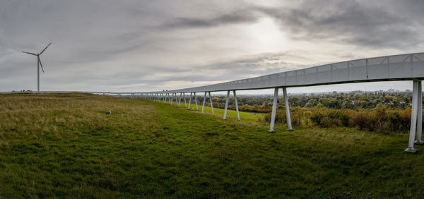 Bridge over field against sky