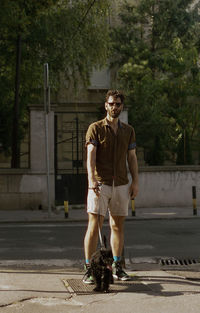 A young man walking a dog