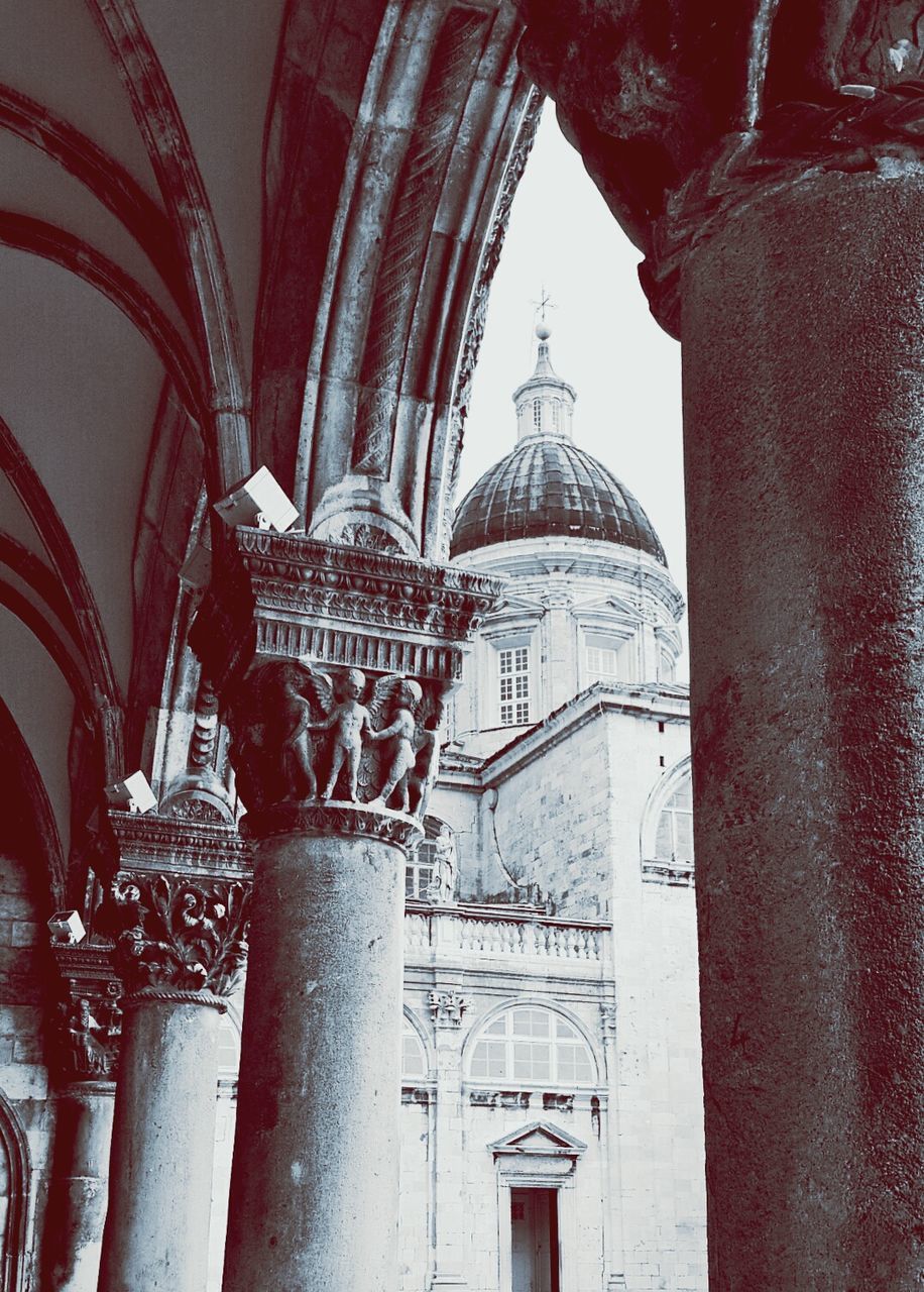 architecture, built structure, building exterior, arch, architectural column, history, place of worship, religion, low angle view, column, historic, entrance, spirituality, day, old, building, travel destinations, sky, facade, outdoors