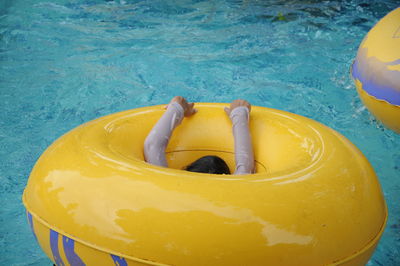 High angle view of yellow floating in swimming pool