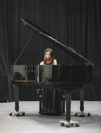 Woman playing on classical piano.