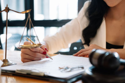 Midsection of woman working at desk