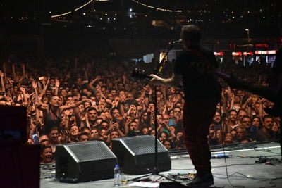 People enjoying music concert at night