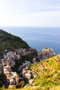 High angle view of townscape by sea against sky
