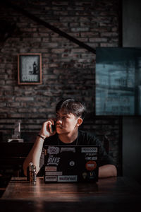 Portrait of boy sitting on table