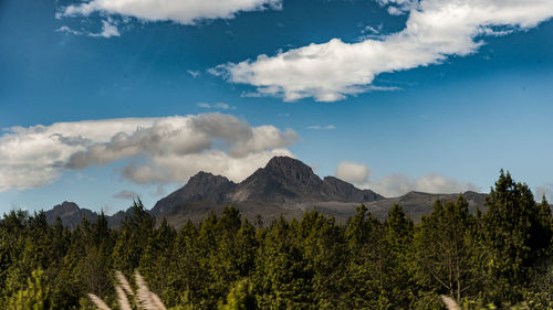 Scenic view of mountains against cloudy sky