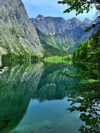 Scenic view of lake and mountains against sky