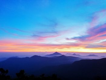 Scenic view of silhouette mountains yong belar  against sky during sunset