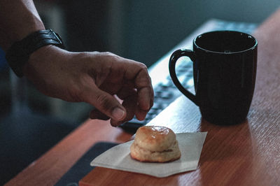 Cropped hands of person preparing food on table