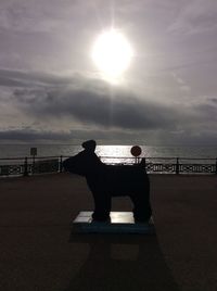 Men in sea against sky