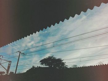 Low angle view of silhouette trees against sky