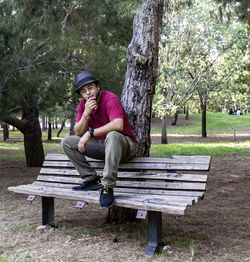 Man sitting on bench in park