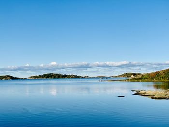 Scenic view of sea against blue sky