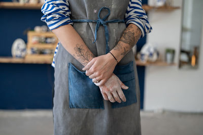 Midsection of man standing in factory