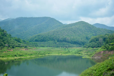 Scenic view of lake and mountains against sky