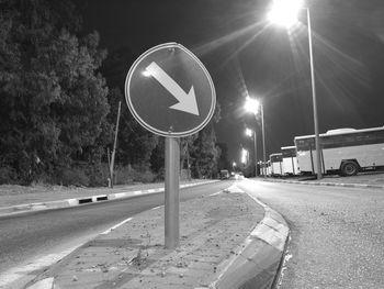 Road sign on street at night