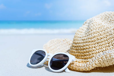 Close-up of sunglasses on beach