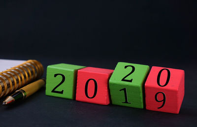 Close-up of toys on table against black background