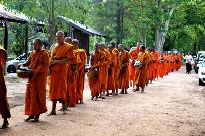 Rear view of people walking in temple