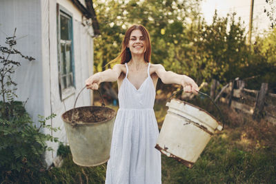 Portrait of a smiling young woman standing outdoors