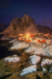 Scenic view of illuminated mountains against sky at night