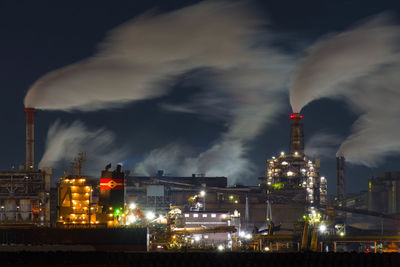 Illuminated buildings against sky at night