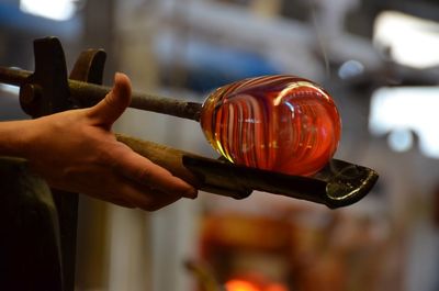 Cropped hand sculpting molten glass