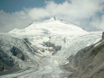 Scenic view of snow covered mountains against sky