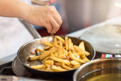 Close-up of person preparing food in kitchen