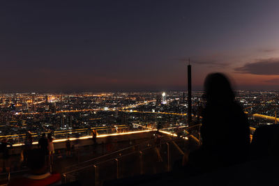 High angle view of illuminated cityscape against sky during sunset