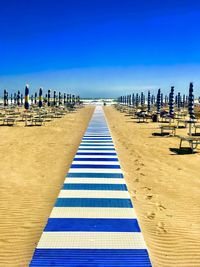 Scenic view of beach against blue sky