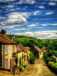 Houses in town against cloudy sky