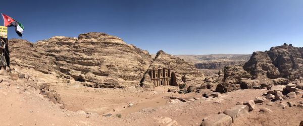 Panoramic view of rocky mountains against clear sky